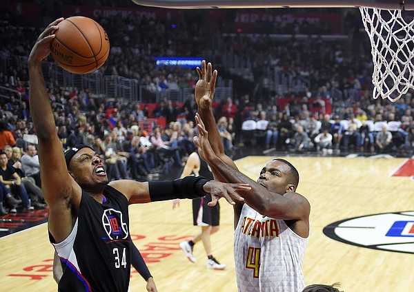 Los Angeles Clippers forward Paul Pierce, left, shoots as Atlanta Hawks forward Paul Millsap defends during the first half of an NBA basketball game, Saturday, March 5, 2016, in Los Angeles. (AP Photo/Mark J. Terrill)