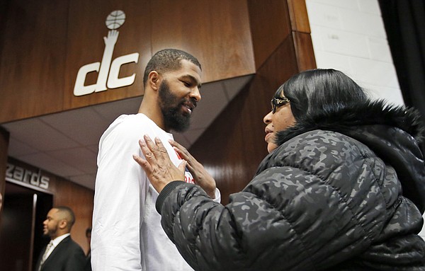 Washington Wizards forward Markieff Morris, front left, talks with his mother Angel Morris, from Clinton, Md., before an NBA basketball game against the Detroit Pistons, Friday, Feb. 19, 2016, in Washington. Markieff just joined the team in a trade from the Phoenix Suns. (AP Photo/Alex Brandon)