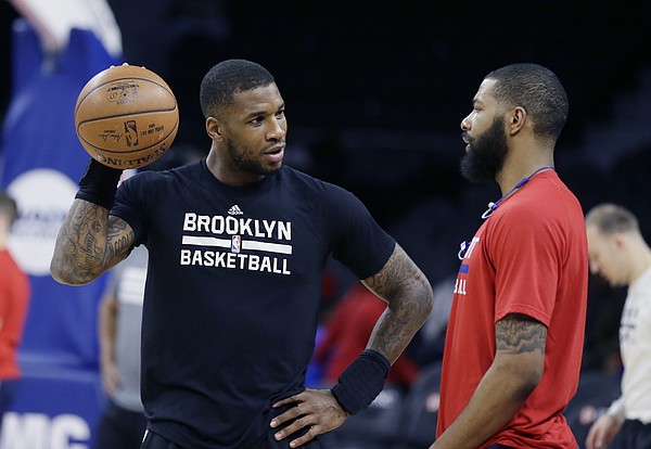 Brooklyn Nets forward Thomas Robinson, left, talks with Detroit Pistons forward Marcus Morris during pre game of an NBA basketball game, Saturday, March 19, 2016, in Auburn Hills, Mich. (AP Photo/Carlos Osorio)