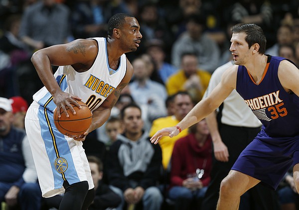 Denver Nuggets forward Darrell Arthur, left, looks to pass the ball as Phoenix Suns forward Mirza Teletovic, of Bosnia, defends in the first half of an NBA basketball game Thursday, March 10, 2016, in Denver. (AP Photo/David Zalubowski)