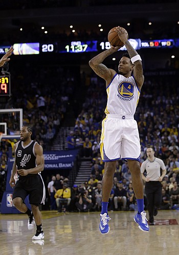 Golden State Warriors' Brandon Rush (4) shoots against the San Antonio Spurs during the first half of an NBA basketball game Thursday, April 7, 2016, in Oakland, Calif. (AP Photo/Marcio Jose Sanchez)
