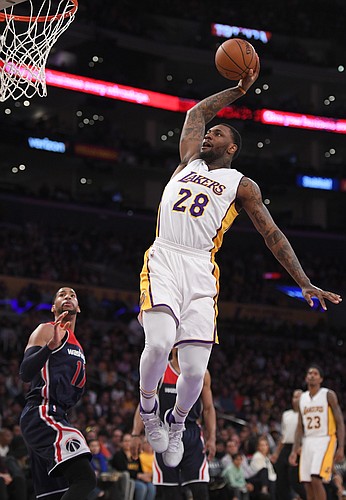 Los Angeles Lakers center Tarik Black, right, tries to dunk and misses as Washington Wizards guard Garrett Temple defends during the second half of an NBA basketball game, Sunday, March 27, 2016, in Los Angeles. The Wizards won 101-88. (AP Photo/Mark J. Terrill)