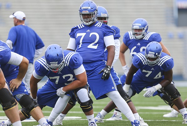 Kansas newcomer, Charles Baldwin, 72, a transfer from Alabama, gets stretched out with the offensive line during practice on Monday, Aug. 15, 2016 at Memorial Stadium.