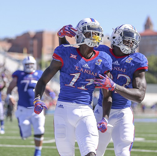Kansas wide receiver Steven Sims Jr. (11) celebrates with teammate Ke'aun Kinner (22) after his second touchdown of the third quarter on Saturday, Sept. 10, 2016 at Memorial Stadium.