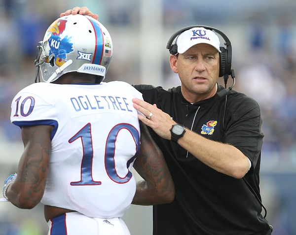 Kansas head coach David Beaty gives a pat to Kansas cornerback Marnez Ogletree (10) as the defense leaves the field following a Memphis touchdown during the second quarter on Saturday, Sept. 17, 2016 at Liberty Bowl Memorial Stadium in Memphis, Tenn.
