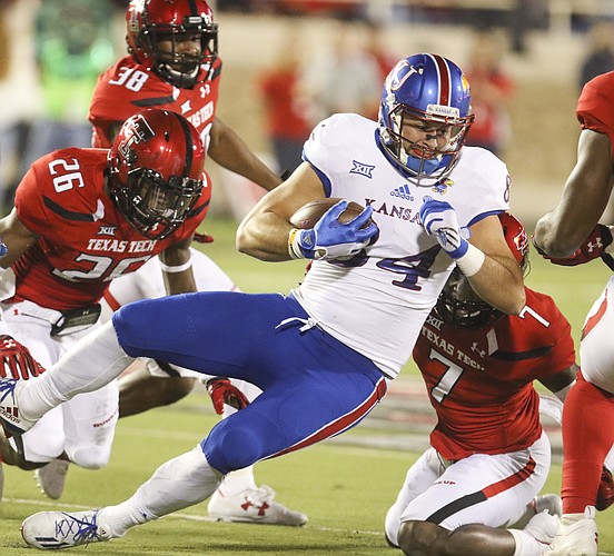 Kansas tight end Ben Johnson (84) is brought down after a catch during the first quarter on Thursday, Sept. 29, 2016 at Jones AT&T Stadium in Lubbock, Texas.
