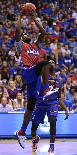 Kansas guard Malik Newman elevates to the bucket past LaGerald Vick during Late Night in the Phog on Saturday, Oct. 1, 2016 at Allen Fieldhouse.