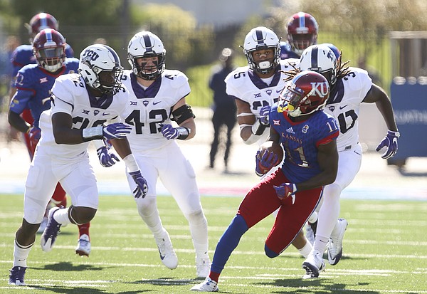 Kansas wide receiver Steven Sims Jr. (11) tears down the field as he is trailed by the TCU defense after a catch during the first quarter on Saturday, Oct. 8, 2016 at Memorial Stadium.