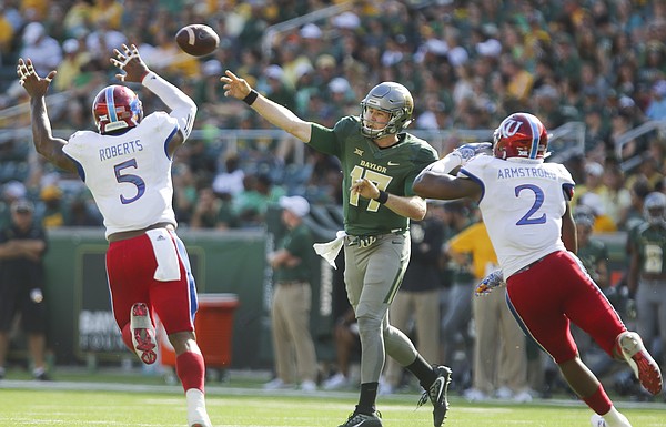 Baylor quarterback Seth Russell (17) throws between Kansas linebacker Marcquis Roberts (5) and defensive end Dorance Armstrong Jr. (2) during the second quarter on Saturday, Oct. 15, 2016 at McLane Stadium in Waco, Texas.