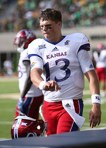 Kansas quarterback Ryan Willis (13) throws his helmet in frustration after throwing his second interception of the game during the second quarter on Saturday, Oct. 15, 2016 at McLane Stadium in Waco, Texas.
