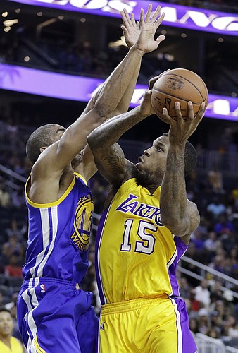 Los Angeles Lakers' Thomas Robinson shoots against Golden State Warriors' James Michael McAdoo during the second half of an NBA preseason basketball game Saturday, Oct. 15, 2016, in Las Vegas. (AP Photo/John Locher)