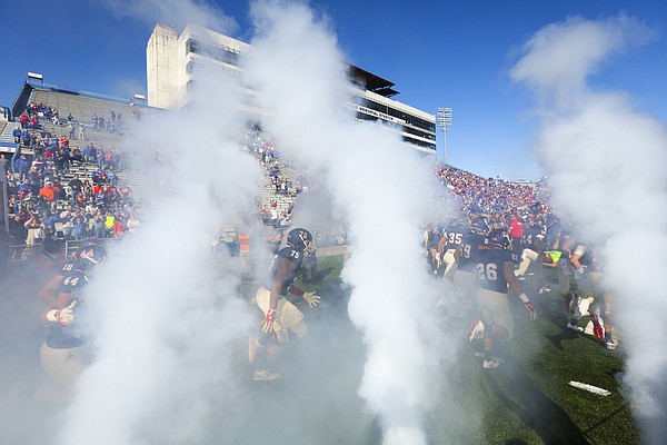 Kansas offensive lineman Antione Frazier (75) and the Jayhawks head out to the field through the smoke prior to kickoff on Saturday, Oct. 22, 2016 at Memorial Stadium.