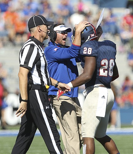 Kansas defensive coordinator Clint Bowen celebrates with linebacker Courtney Arnick after a defensive stop  during the third quarter on Saturday, Oct. 22, 2016 at Memorial Stadium.