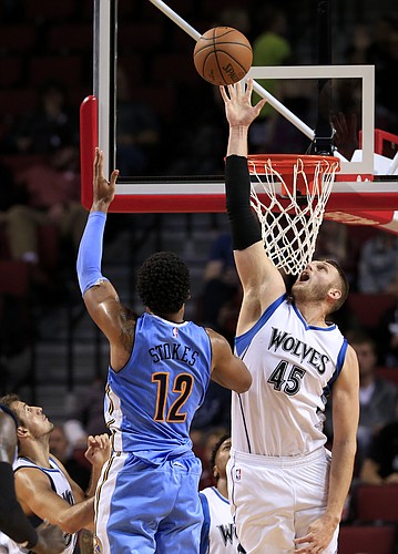 Minnesota Timberwolves center Cole Aldrich (45) blocks a shot by Denver Nuggets forward Jarnell Stokes (12) during the second half of an NBA preseason basketball game in Lincoln, Neb., Wednesday, Oct. 12, 2016. The Minnesota Timberwolves won 105-88. (AP Photo/Nati Harnik)