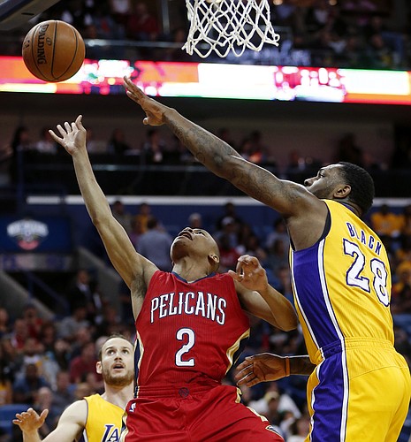 New Orleans Pelicans guard Tim Frazier (2) goes to the basket against Los Angeles Lakers center Tarik Black (28) during the first half of an NBA basketball game in New Orleans, Friday, April 8, 2016. (AP Photo/Gerald Herbert)