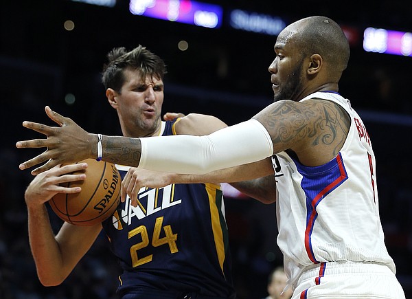 Utah Jazz center Jeff Withey (24) pulls away a rebound from Los Angeles Clippers center Marreese Speights (5) during the second half of an NBA preseason basketball game in Los Angeles, Monday, Oct. 10, 2016. The Jazz won 96-94. (AP Photo/Alex Gallardo)