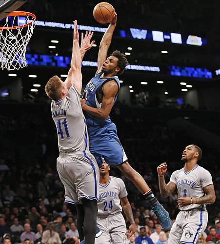Minnesota Timberwolves forward Andrew Wiggins (22) shoots over Brooklyn Nets center Justin Hamilton (41) during the first half of an NBA basketball game, Tuesday, Nov. 8, 2016, in New York. (AP Photo/Kathy Willens)