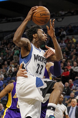 Minnesota Timberwolves forward Andrew Wiggins (22) drives to the basket and is fouled by Los Angeles Lakers center Timofey Mozgov (20) in the first half of an NBA basketball game, Sunday, Nov. 13, 2016, in Minneapolis. (AP Photo/Bruce Kluckhohn)