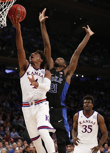 Kansas guard Devonte' Graham (4) gets in for a bucket past Duke forward Amile Jefferson (21) during the second half of the Champions Classic on Tuesday, Nov. 15, 2016 at Madison Square Garden in New York.