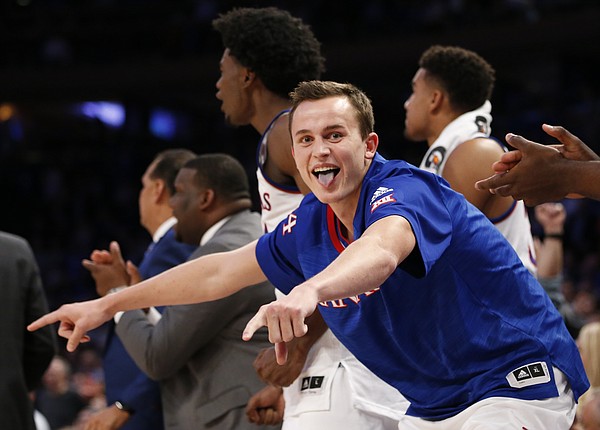 Kansas forward Mitch Lightfoot celebrates a bucket by teammate Frank Mason III during the second half of the Champions Classic on Tuesday, Nov. 15, 2016 at Madison Square Garden in New York.