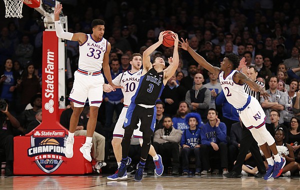 The Kansas defense tries to rip away a ball from Duke guard Grayson Allen (3) during the second half of the Champions Classic on Tuesday, Nov. 15, 2016 at Madison Square Garden in New York.