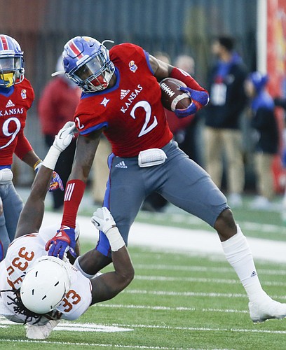 Kansas defensive end Dorance Armstrong Jr. (2) puts Texas running back D'Onta Foreman (33) on the ground after recovering a fumble during the second quarter on Saturday, Nov. 19, 2016 at Memorial Stadium.