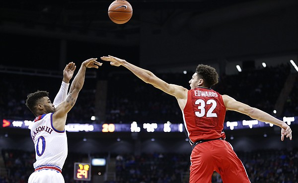 Kansas guard Frank Mason III (0) puts up a three from the corner over Georgia forward Mike Edwards (32) during the first half, Tuesday, Nov. 22, 2016 during the championship game of the CBE Classic at Sprint Center.