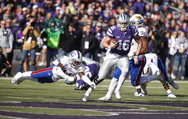 Kansas State quarterback Jesse Ertz (16) avoided a tackle from Kansas safety Mike Lee (11) during the second quarter, Saturday, Nov. 26, 2016 at Bill Snyder Family Stadium.
