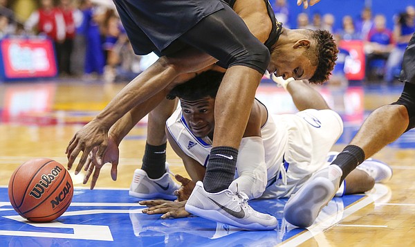 Kansas guard Josh Jackson (11) tries to regain a lost ball between the legs of Long Beach State forward LaRond Williams during the second half, Tuesday, Nov. 29, 2016 at Allen Fieldhouse.