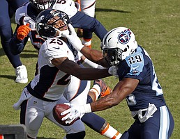 Tennessee Titans running back DeMarco Murray (29) pushes Denver Broncos cornerback Chris Harris (25) aside in the first half of an NFL football game Sunday, Dec. 11, 2016, in Nashville, Tenn. (AP Photo/Weston Kenney)