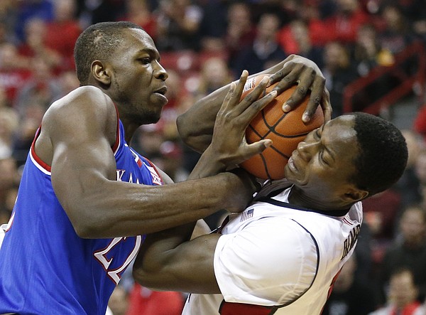 Kansas forward Dwight Coleby (22) wrestles for a ball with UNLV forward Cheickna Dembele (11) during the first half, Thursday, Dec. 22, 2016 at Thomas & Mack Center in Las Vegas.