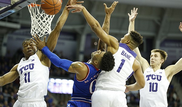 Kansas guard Frank Mason III (0) is fouled hard by TCU guard Desmond Bane (1) during the first half, Friday, Dec. 30, 2016 at Schollmaier Arena in Fort Worth, Texas