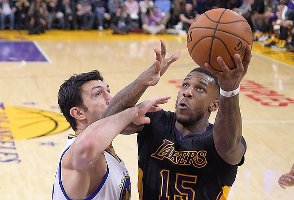 Los Angeles Lakers forward Thomas Robinson, right, shoots as Golden State Warriors center Zaza Pachulia, of the Republic of Georgia, defends during the second half of an NBA basketball game, Friday, Nov. 25, 2016, in Los Angeles. The Warriors won 109-85. (AP Photo/Mark J. Terrill)