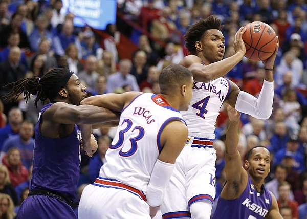 Kansas guard Devonte' Graham (4) look to pass during the first half, Tuesday, Jan. 3, 2017 at Allen Fieldhouse.