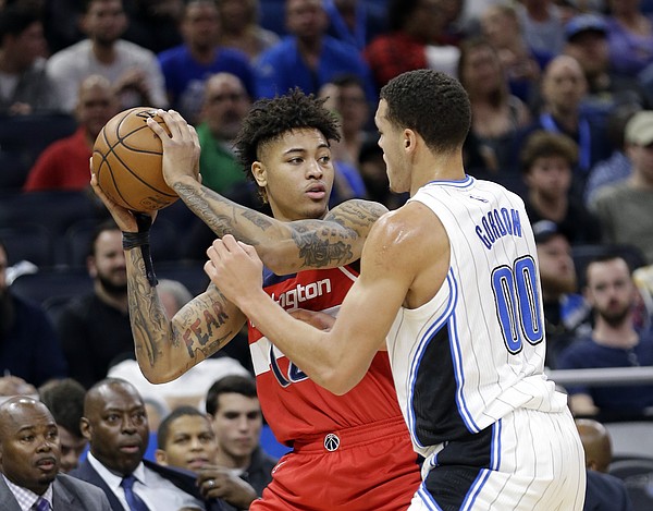 Washington Wizards' Kelly Oubre Jr., left, looks to pass the ball as he is defended by Orlando Magic's Aaron Gordon (00) during the first half of an NBA basketball game, Friday, Nov. 25, 2016, in Orlando, Fla. (AP Photo/John Raoux)