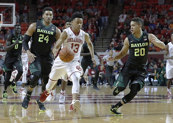 Oklahoma guard Jordan Shepherd (13) brings the ball up as Baylor guards Ishmail Wainright (24) and Manu Lecomte (20) defend during the second half of an NCAA college basketball game in Norman, Okla., on Friday, Dec. 30, 2016.