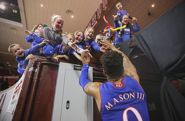 Kansas guard Frank Mason III (0) slaps hands with a gathering of Jayhawk fans following their 81-70 win over Oklahoma on Tuesday, Jan. 10, 2017 at Lloyd Noble Center in Norman, Okla.