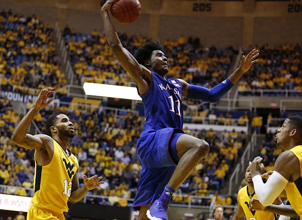 Kansas guard Josh Jackson (11) elevates for a dunk against West Virginia during the second half, Tuesday, Jan. 24, 2017 at WVU Coliseum.