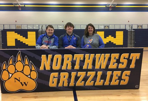 Wichita Northwest offensive lineman Joey Gilbertson poses for photos after signing with Kansas football, on Feb. 1, 2017.