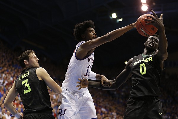 Kansas guard Josh Jackson (11) fights for a rebound with Baylor forward Jo Lual-Acuil Jr. (0) during the second half, Wednesday, Feb. 1, 2017 at Allen Fieldhouse. At left is Baylor guard Jake Lindsey (3).