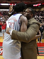 Kansas guard Josh Jackson (11) gets a hug from assistant coach Jerrance Howard as he leaves the floor following the Jayhawks' 80-79 win over Texas Tech, Saturday, Feb. 11, 2017 at United Supermarkets Arena in Lubbock, Texas.