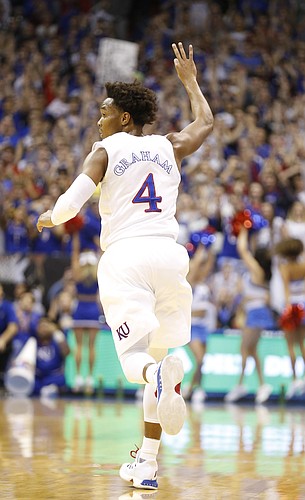 Kansas guard Devonte' Graham (4) raises his hand after hitting a three during the first half, Monday, Feb. 27, 2017 at Allen Fieldhouse