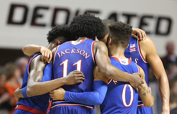 The Jayhawks come together in a huddle with little time remaining during the second half, Saturday, March 4, 2017 at Gallagher-Iba Arena. 