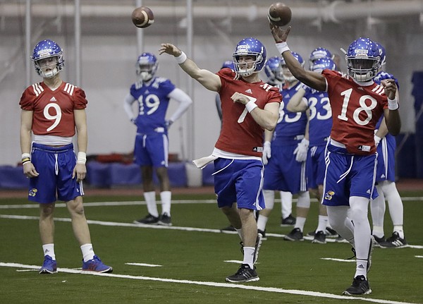 The Kansas football team practices inside Anschutz Pavilion, Monday, March 13, 2017. The practice was the first of the spring for the Jayhawks, including quarterbacks (from left) Carter Stanley, Peyton Bender and Tyriek Starks.