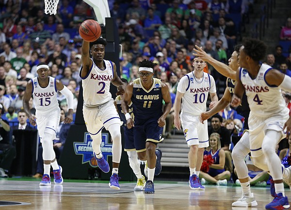 Kansas guard Lagerald Vick (2) pushes the ball up the court to Kansas guard Devonte' Graham (4) during the first half on Friday, March 17, 2017 at BOK Center in Tulsa, Oklahoma.