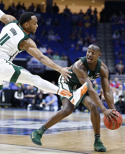 Michigan State guard Joshua Langford (1) looks to throw  pass around Miami guard Bruce Brown (11) during the second half on Friday, March 17, 2017 at BOK Center in Tulsa, Oklahoma.
