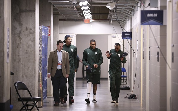 Michigan State guards Miles Bridges, second from left, Alvin Ellis III and Lourawls Nairn Jr. are escorted to interviews on Saturday, March 18, 2017 at BOK Center in Tulsa, Okla.