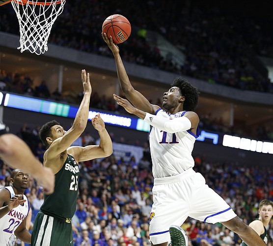 Kansas guard Josh Jackson (11) goes in for a bucket against Michigan State forward Kenny Goins (25) during the second half on Sunday, March 19, 2017 at BOK Center in Tulsa, Okla.