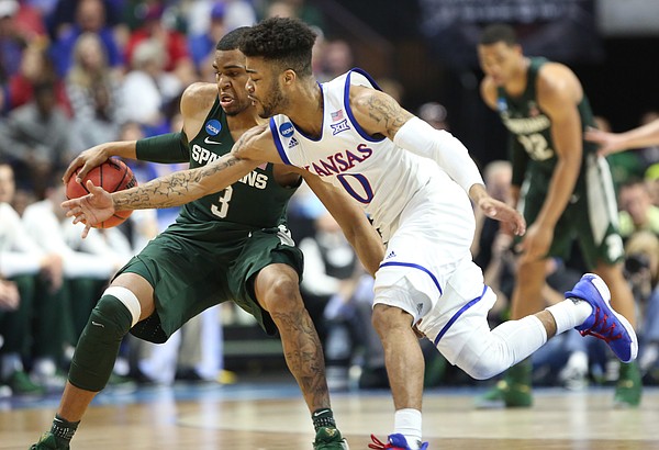 Kansas guard Frank Mason III (0) nearly gets a steal from Michigan State guard Alvin Ellis III (3) during the second half on Sunday, March 19, 2017 at BOK Center in Tulsa, Okla.