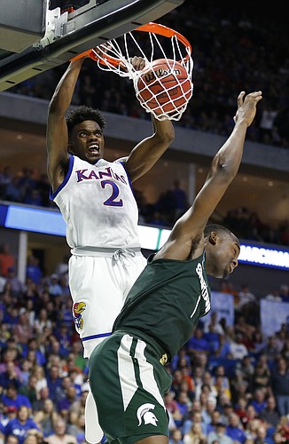 Kansas guard Lagerald Vick (2) delivers a dunk over Michigan State guard Joshua Langford (1) during the second half on Sunday, March 19, 2017 at BOK Center in Tulsa, Okla.